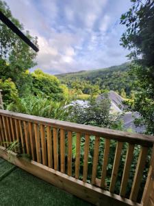 a wooden balcony with a view of the mountains at Glendalough Sanctuary in Brockagh