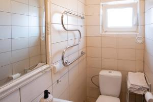a bathroom with a toilet and a window at Nida Inn Self Check-in in Nida +12 photos
