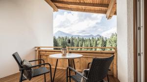a table and chairs on a balcony with a view at apartments '43 in Reith im Alpbachtal