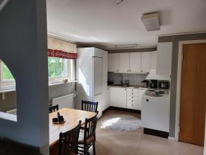 a kitchen with a table and chairs in a room at Apartment with some lake view in Sävsjöström
