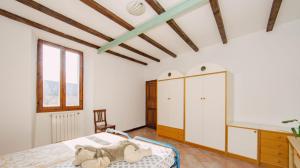 a bedroom with a bed with a teddy bear on it at ERmETE in Tortona