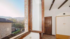 a large mirror in a room with a window at ERmETE in Tortona