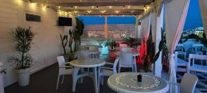 a patio with tables and chairs on a balcony at Silvia Casa Vacanze in Porto Cesareo