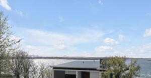 a house with a view of a body of water at Ocean-Side Family Villa in Reykjavík