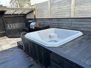 a bath tub sitting on top of a wooden deck at Ocean-Side Family Villa in Reykjavík