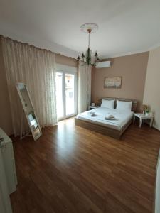 a large bedroom with a bed and a mirror at Kavala Penthouse in Kavála