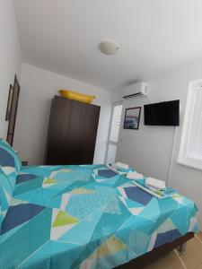 a bed with a colorful comforter in a bedroom at SEA SKY View in Byala