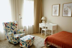 a bedroom with a chair and a desk and a bed at Center of city apartments, bus station 1min, airport 5 min in Tallinn
