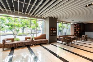 a lobby with couches and tables in a building at Hotel Forza Oita in Oita +80 photos