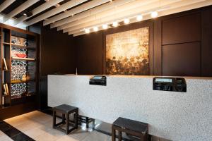 a bar in a restaurant with two stools at Hotel Forza Oita in Oita