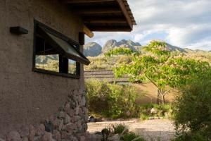 a window of a building with mountains in the background at Casa Nativa in Mendoza