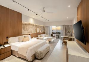 a bedroom with a large bed and a living room at Grand Velas Riviera Nayarit-All Inclusive in Nuevo Vallarta