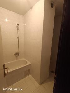 a white bathroom with a tub and a shower at Nedzarici sobe in Sarajevo