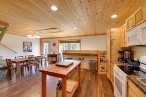 a kitchen and dining room with a table and chairs at Walk to Flathead Lake! Home w/ Deck & Fenced Yard! in Lakeside