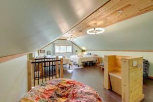 a bedroom with a bed and a room with two beds at Walk to Flathead Lake! Home w/ Deck & Fenced Yard! in Lakeside