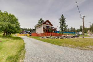 a house sitting on the side of a road at Walk to Flathead Lake! Home w/ Deck & Fenced Yard! in Lakeside