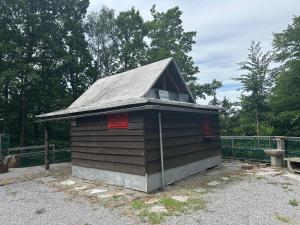 a smallshed with a roof on top of it at Palčkov oddih in Škofja Loka +8 photos