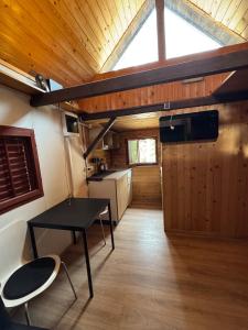 a room with a table and a kitchen in a house at Palčkov oddih in Škofja Loka