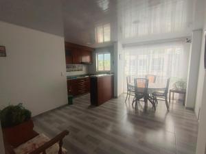 a kitchen and dining room with a table and chairs at Casa Bercel in Choachí