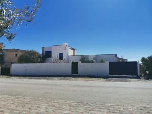 a white fence in front of a building at استراحة الوداد in Qurayyah +9 photos