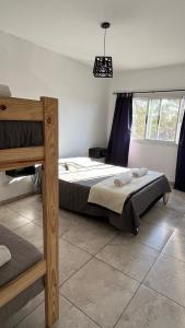 a bedroom with a bed and a large window at Travel Suites Ezeiza- 5 pax- Centro Eze- Shoppings a 8 min in Ezeiza
