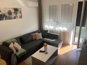 a living room with a couch and a coffee table at Apartment VIP in Subotica +38 photos