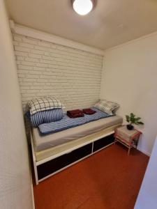 a small bed in a room with a brick wall at Nice appartment in city center Gol,free Wifi and electric in Gol