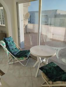 a table and two chairs and a table and a table at Dar Fouzia in Hammamet Sud