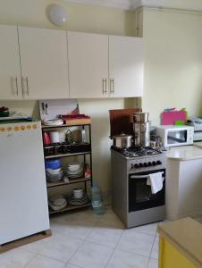 a kitchen with a stove and a microwave at Dar Fouzia in Hammamet Sud