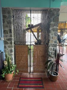 a iron gate with plants in front of a building at Trinity Point Hillside Villa, beach & sunset views in Bequia