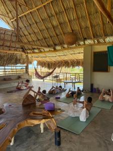 a group of people doing yoga in a hut at Casa Mambo Salinas in Santa Verónica