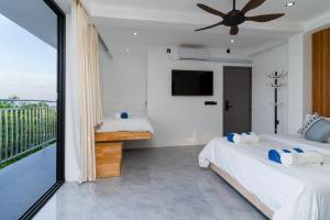 a bedroom with two beds and a balcony at Seaside Oceanview in Ukulhas