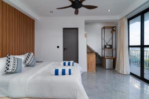 a bedroom with a large bed with a ceiling fan at Seaside Oceanview in Ukulhas