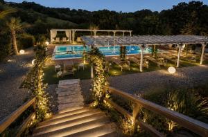 a house with a swimming pool at night at Casale Serena 1912 in Fabro