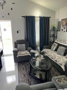 a living room with a couch and a coffee table at Comfort Rest - Whim in Old Harbour