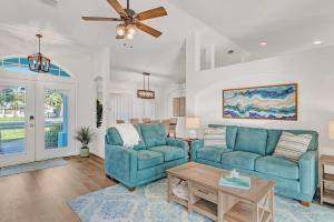 a living room with two blue couches and a table at Beach Getaway - Pool & 2 King Beds in Sebastian