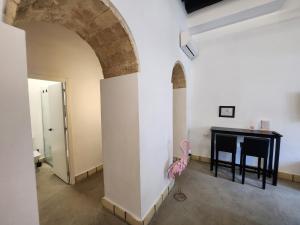 a pink flamingo standing next to a table in a room at CAMASanlúcar in Sanlúcar de Barrameda +20 photos