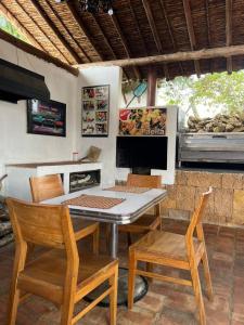 a dining room with a table and two chairs at Cabaña VillaMaria in Villanueva