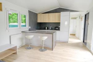 a kitchen with white cabinets and a counter top at Domek w Suchaczu in Suchacz