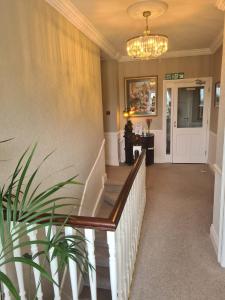 a hallway of a home with a staircase and a chandelier at Shannonside House N37HF67 in Athlone