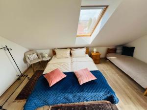 a bedroom with a bed with two pillows on it at Fenyves Appartman in Pécsely