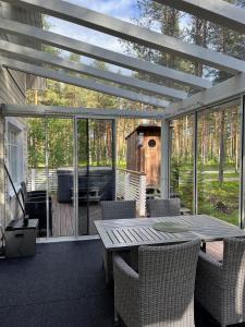 a patio with a table and chairs on a deck at Kurjenpesä in Kalajoki