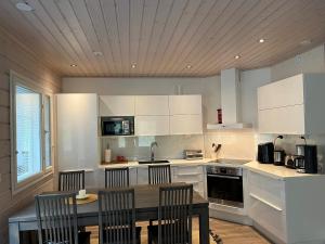 a kitchen with a table and chairs in it at Kurjenpesä in Kalajoki