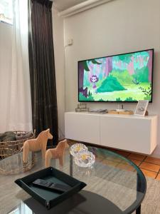 a living room with a flat screen tv on a wall at Sundsvall By M - Basement Studio in Sundsvall