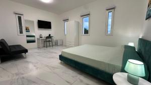 a bedroom with a bed and a desk and a chair at Panorama Terrace - Como Lake in Como