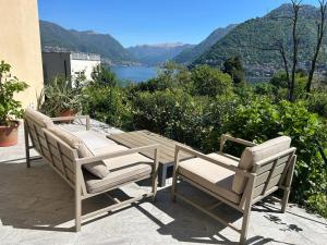 two chairs and a table on a patio with a view at Panorama Terrace - Como Lake in Como