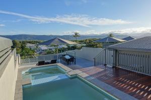 a swimming pool on top of a house at Coconut Grove in Port Douglas