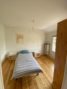 a bedroom with a bed and a wooden floor at Mathéro in Saint-Pair-sur-Mer