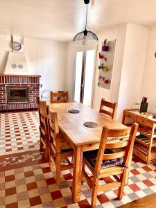 a dining room with a wooden table and chairs at Mathéro in Saint-Pair-sur-Mer