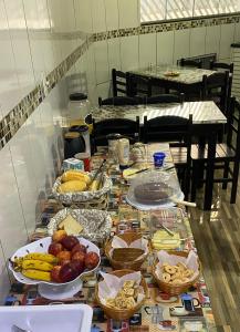 a table with many plates of food on it at Pousada São Miguel Arcanjo in Aparecida